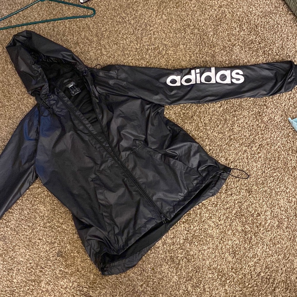 Adidas black rain jacket. In new like condition.